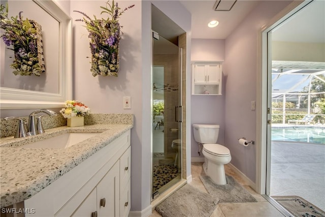 bathroom featuring tile patterned flooring, toilet, vanity, baseboards, and a shower stall