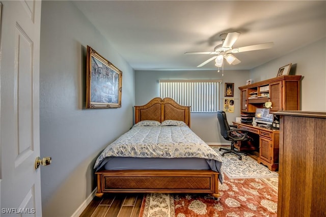 bedroom with baseboards, dark wood finished floors, and a ceiling fan