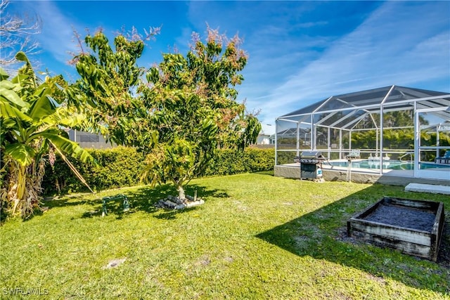 view of yard with glass enclosure and an outdoor pool