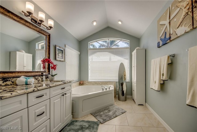 full bath featuring baseboards, lofted ceiling, tile patterned floors, a garden tub, and vanity