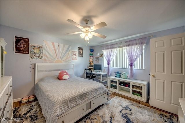 bedroom featuring a ceiling fan and wood finished floors