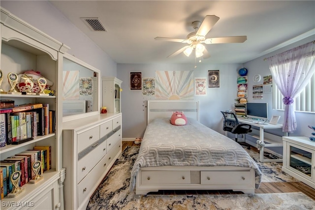 bedroom with ceiling fan, wood finished floors, and visible vents