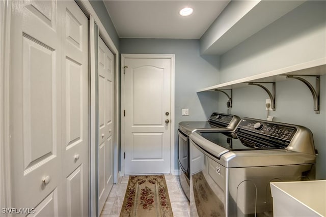 laundry room featuring laundry area, separate washer and dryer, and a sink