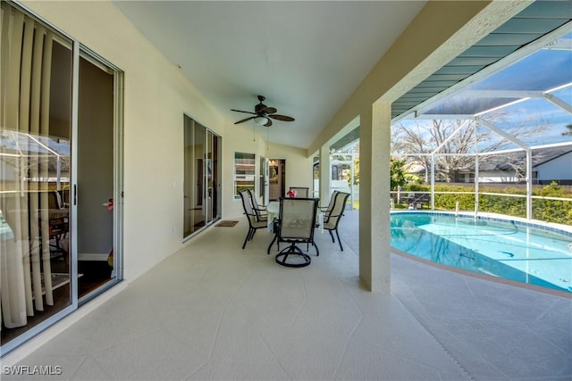 pool with ceiling fan, outdoor dining area, a patio area, and a lanai