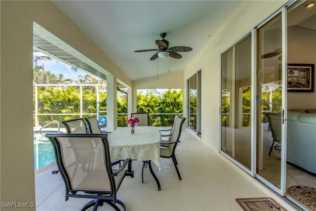 sunroom / solarium featuring lofted ceiling and ceiling fan