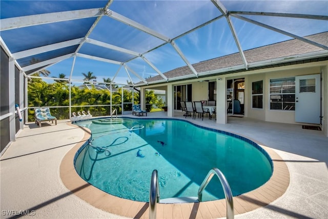 outdoor pool with a lanai and a patio