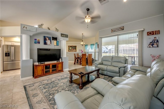 living area with vaulted ceiling, light tile patterned flooring, ceiling fan with notable chandelier, and visible vents