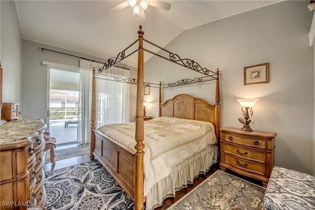 bedroom with vaulted ceiling, dark wood-style flooring, a ceiling fan, and access to exterior