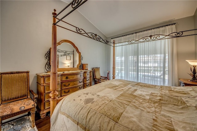 bedroom featuring vaulted ceiling and wood finished floors