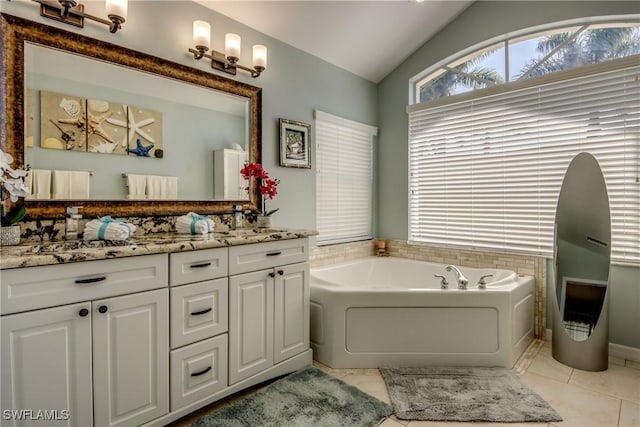 full bath featuring tile patterned flooring, vaulted ceiling, a bath, and vanity