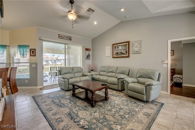 living area featuring lofted ceiling, baseboards, visible vents, and a ceiling fan