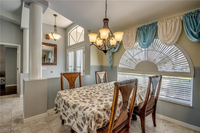 dining space with plenty of natural light, baseboards, a chandelier, and french doors