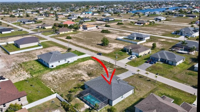 birds eye view of property featuring a residential view and a water view