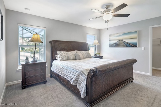 bedroom featuring baseboards, carpet floors, ceiling fan, and a spacious closet