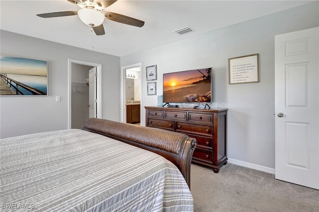 bedroom featuring visible vents, baseboards, ceiling fan, a spacious closet, and light colored carpet