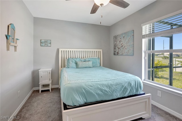 carpeted bedroom with a ceiling fan and baseboards