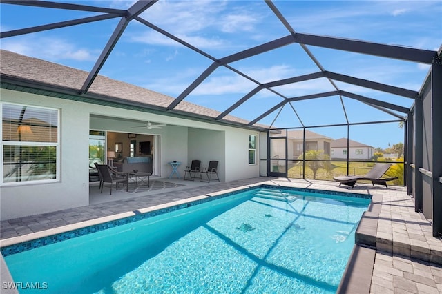 outdoor pool featuring a patio area, a lanai, and a ceiling fan