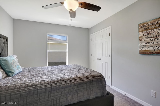 bedroom with a closet, ceiling fan, baseboards, and carpet