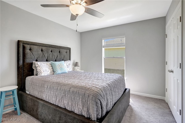 carpeted bedroom with baseboards and a ceiling fan