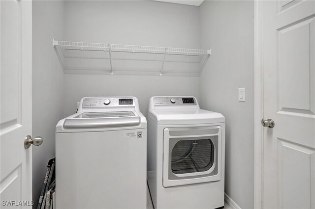 washroom featuring laundry area and washer and dryer