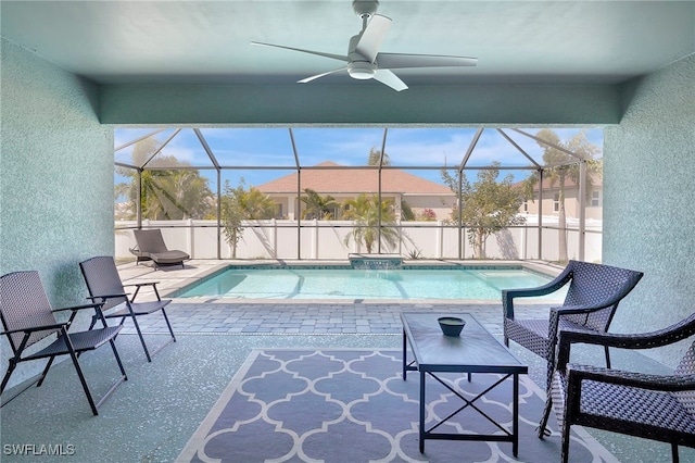 view of pool with glass enclosure, a patio, a fenced in pool, and ceiling fan