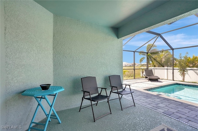 view of swimming pool featuring a fenced in pool, a patio, and a lanai