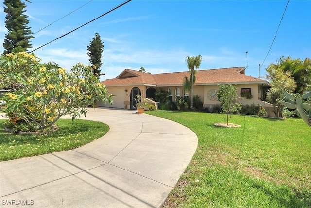 1442 SE 15th Ter, Cape Coral, FL 33990 - ranch-style house with stucco siding, curved driveway, a front yard, and a garage
