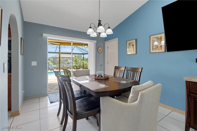 1442 SE 15th Ter, Cape Coral, FL 33990 - dining space with arched walkways, lofted ceiling, baseboards, a chandelier, and light tile patterned floors