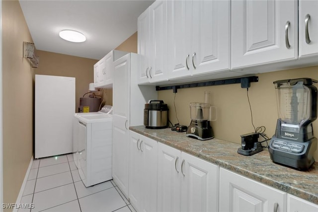 1442 SE 15th Ter, Cape Coral, FL 33990 - laundry room with cabinet space, light tile patterned floors, washing machine and dryer, and electric water heater