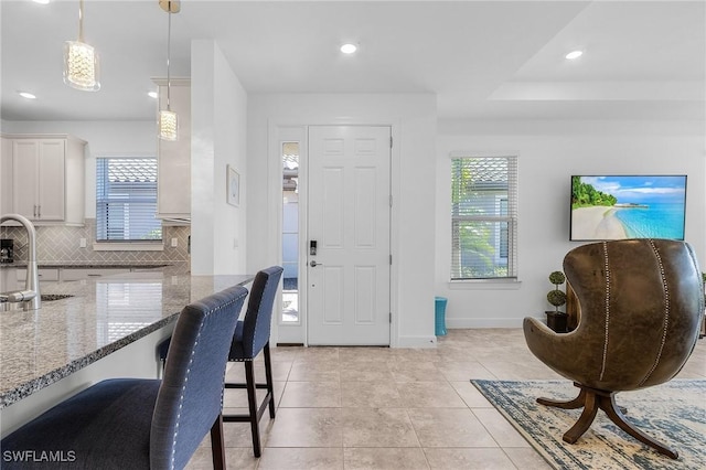 foyer with plenty of natural light, recessed lighting, and light tile patterned floors