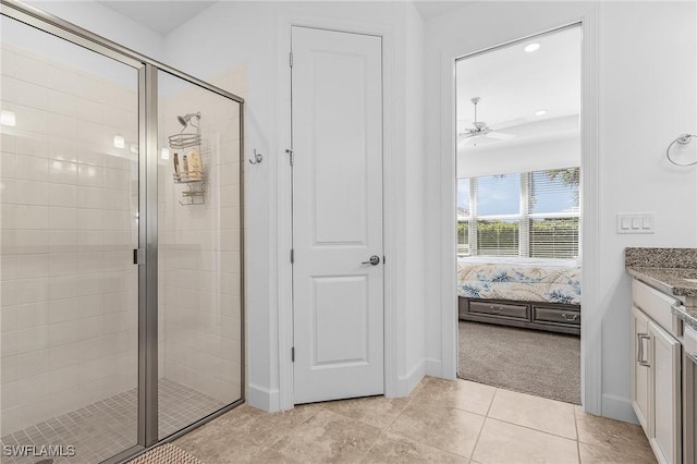 ensuite bathroom featuring tile patterned flooring, a stall shower, vanity, and ensuite bathroom