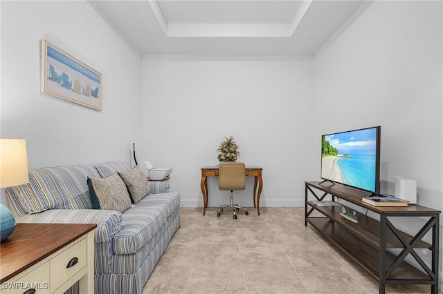 home office featuring baseboards and a tray ceiling