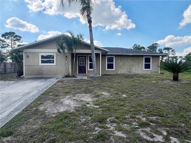 single story home featuring a front yard and fence