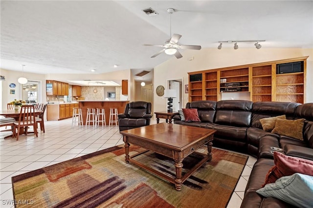 living room featuring light tile patterned floors, ceiling fan, lofted ceiling, and visible vents