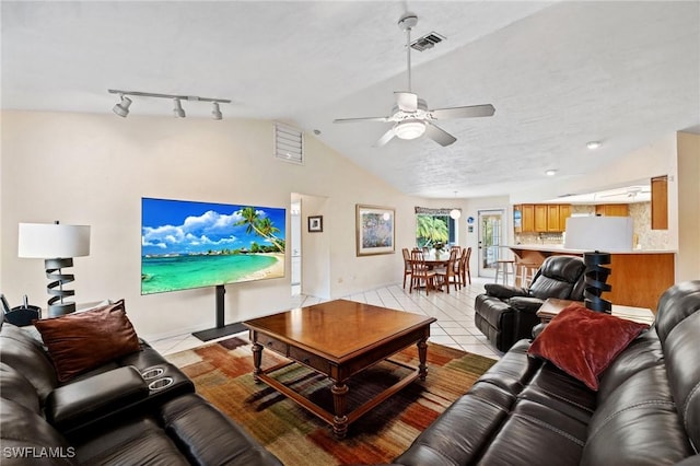 living room featuring light tile patterned floors, lofted ceiling, visible vents, rail lighting, and a ceiling fan