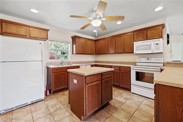 kitchen featuring light tile patterned floors, light countertops, white appliances, and a sink