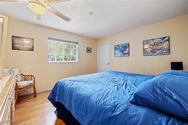 bedroom with baseboards, ceiling fan, and light wood finished floors