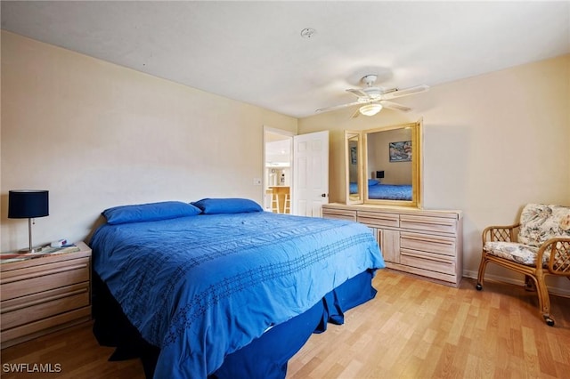 bedroom with wood finished floors, a ceiling fan, and baseboards