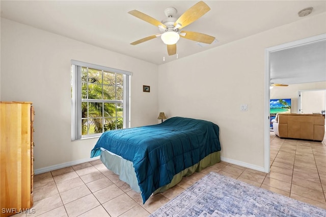 bedroom featuring ceiling fan, baseboards, and light tile patterned floors