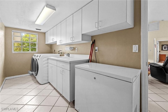 laundry room with cabinet space, independent washer and dryer, visible vents, and light tile patterned floors