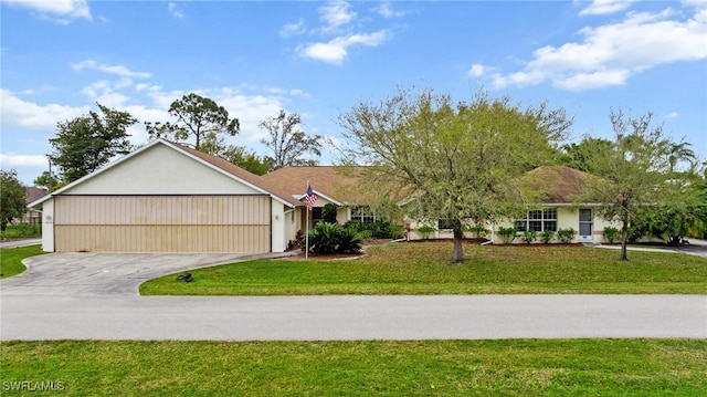 ranch-style house featuring an attached garage, concrete driveway, and a front yard