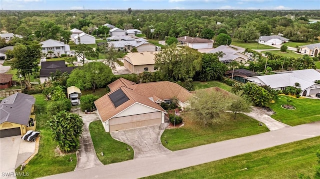 birds eye view of property with a residential view and a view of trees