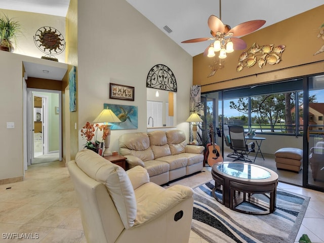 living room featuring baseboards, visible vents, a ceiling fan, high vaulted ceiling, and light tile patterned flooring