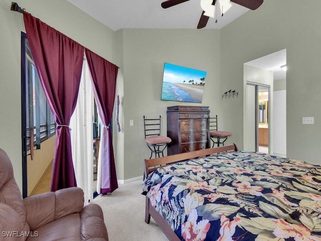 bedroom featuring carpet flooring, vaulted ceiling, ceiling fan, ensuite bath, and baseboards