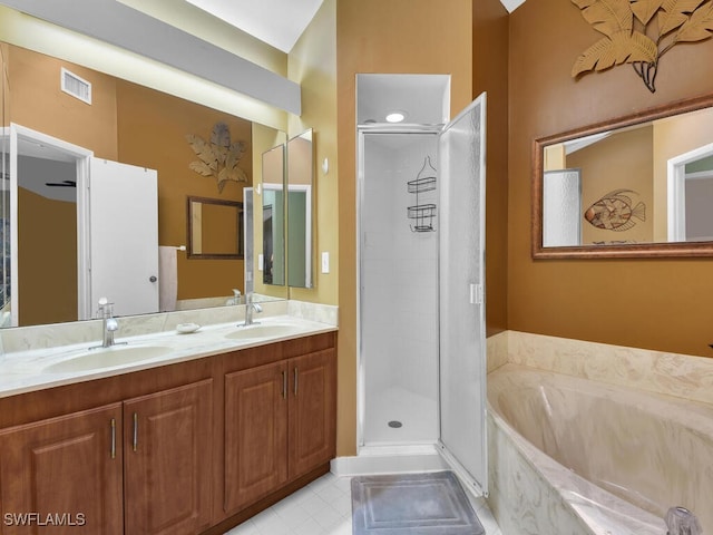 full bath featuring double vanity, a stall shower, a sink, and a bath