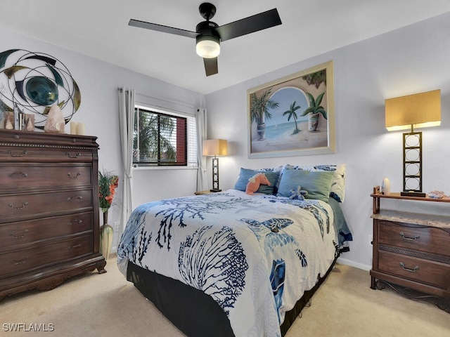 bedroom featuring a ceiling fan, light colored carpet, and baseboards