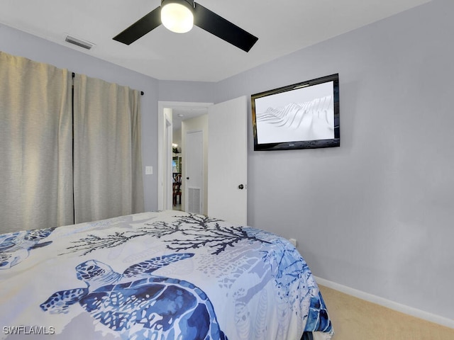 bedroom featuring carpet floors, a ceiling fan, visible vents, and baseboards