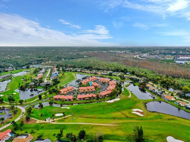 birds eye view of property with view of golf course and a water view