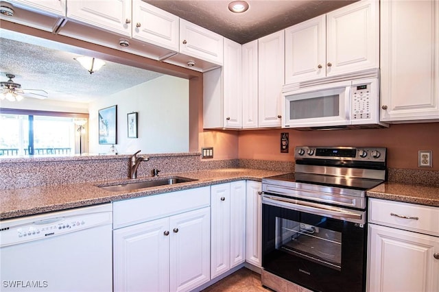 kitchen with a sink, a textured ceiling, white appliances, white cabinets, and ceiling fan