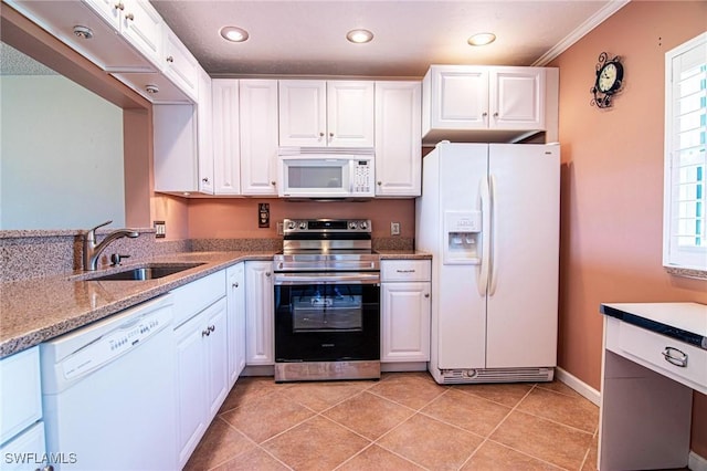 kitchen featuring white cabinets, white appliances, and a sink